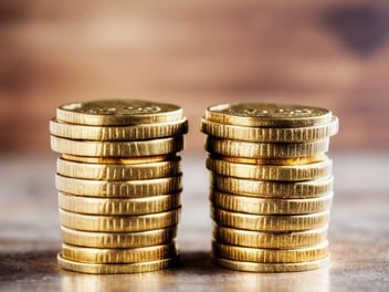 Two stacks of gold coins. Double the value of your business!